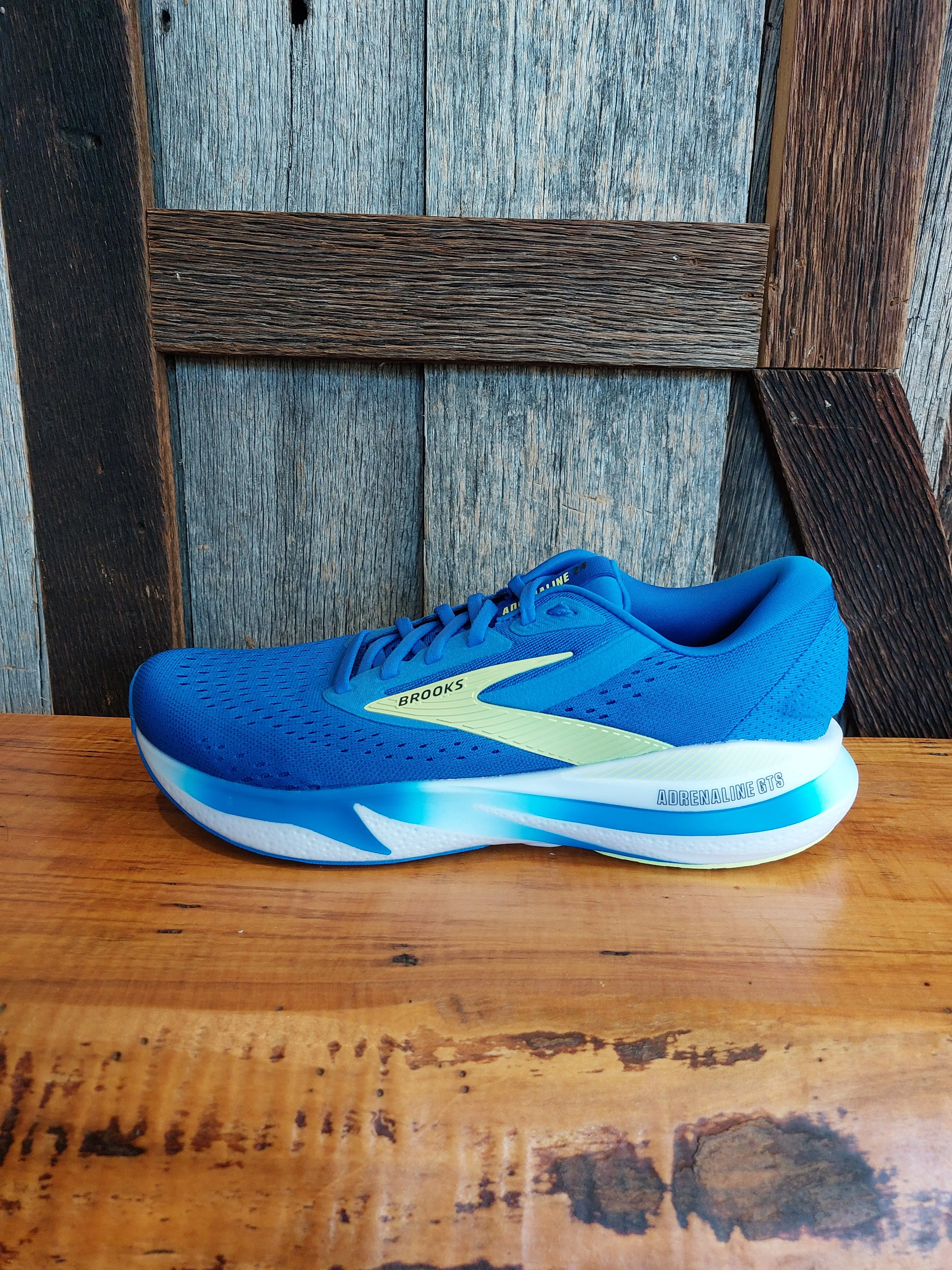 M Brooks Adrenaline GTS 24 running in a seagrass meadow area shoes running in color runs shoes